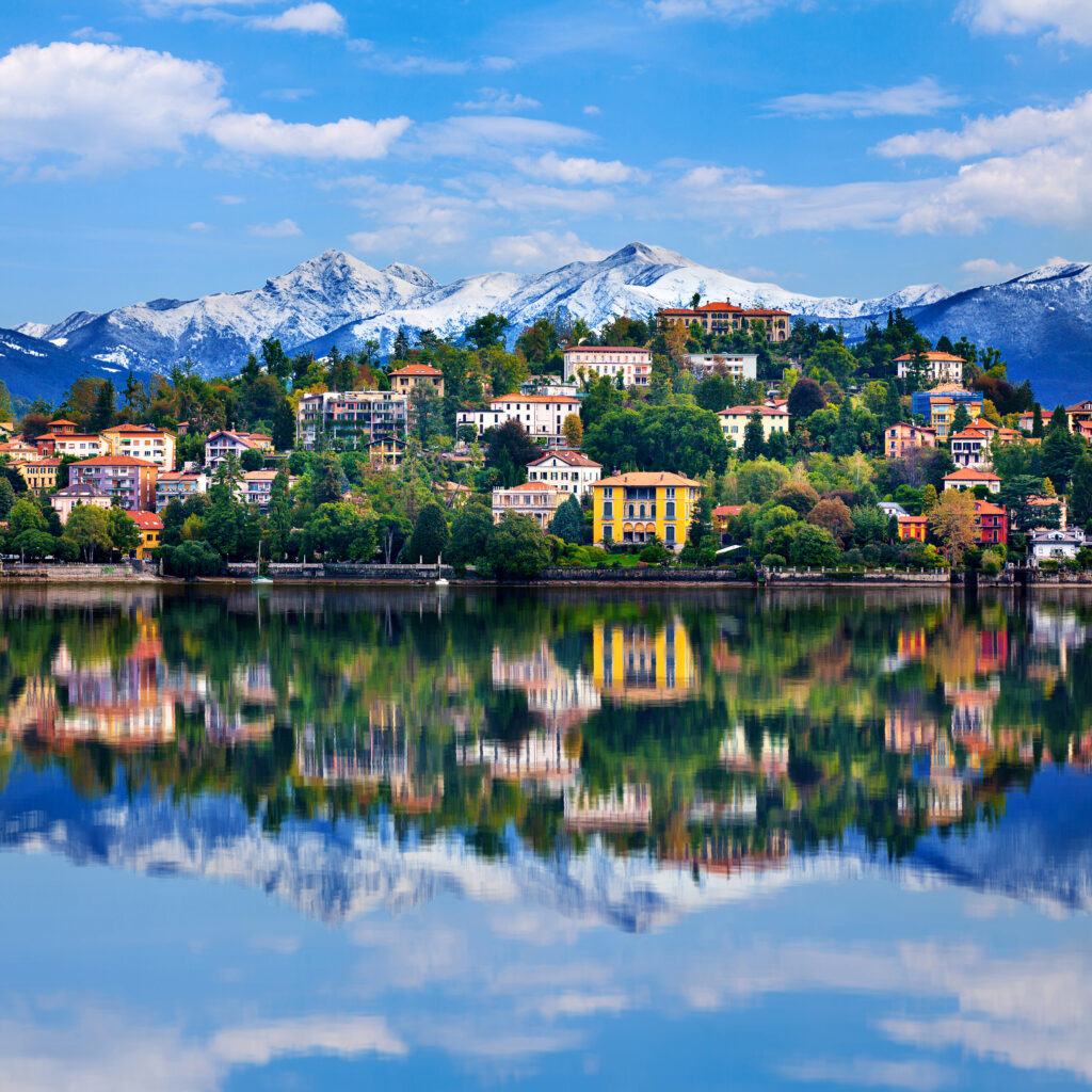 View,Over,Lake,Maggiore,And,Alps,Mountains,With,Verbania,Town